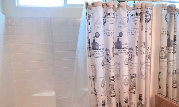 Shower curtain and liner hanging in a shower and how to wash fabric, plastic and vinyl curtain liners to remove mold, mildew and bacteria.
